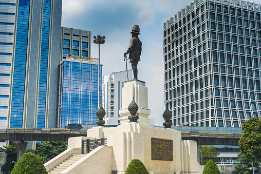 Bangkok, Thailand - 5 November 2023: King Rama VI Monument (King Vajiravudh) and skyscrappers in Bangkok city, Lumphini Park. The monument was built in 1941 by Corrado Feroci, an Italian sculptor