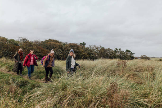 istock Women's Walk Through Dunes by the Sea 1837328675