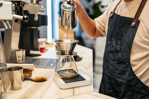 Young Barista Making A Pour-Over Coffee In A Coffee Shop In Kuwait