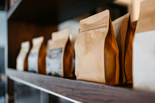 Different types of coffee sorted out in paper bags on the shelf in a coffee shop in Kuwait City in Kuwait.