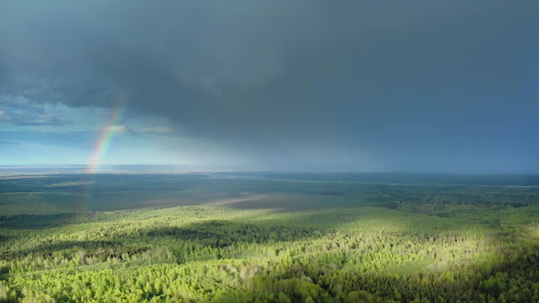 Rainbow in the sky against the rain, drone shot. Aerial Drone Shot.