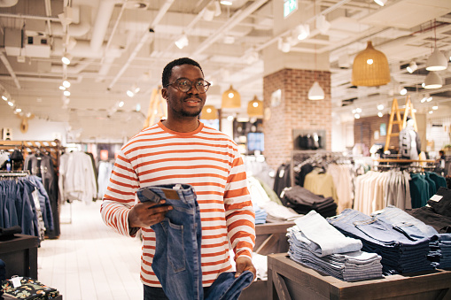 Young black man buys jeans