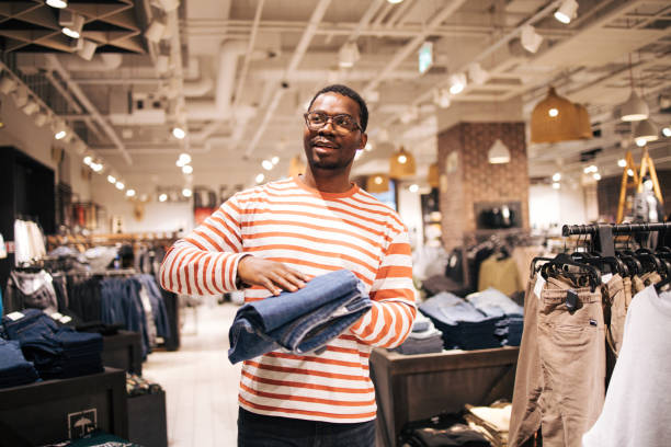 istock Young black man at shopping buying jeans 1837387197