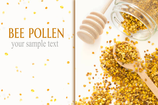 Bee pollen granules crumbled from glass jar n white background. Healthy nutrition.