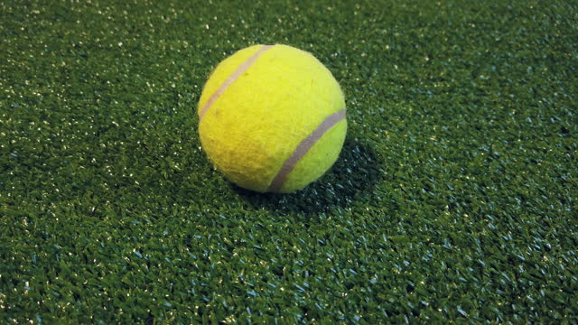 Tennis ball on an artificial turf field. High quality 4k footage