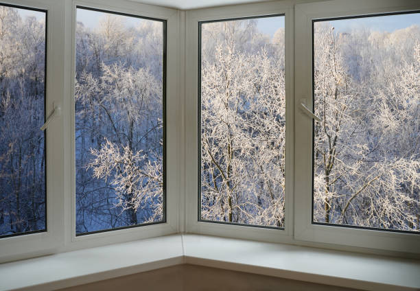 istock View from the window on a winter landscape with blue sky,  trees and falling snow. 1837408429