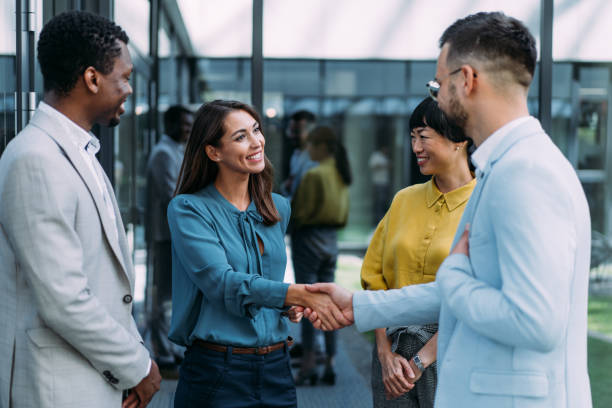 Successful partnership. Businesspeople handshaking in front of modern office building. employee introduction stock pictures, royalty-free photos & images