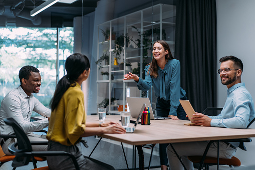 Shot of a businesswoman giving a presentation in the office board room. Group of business persons in business meeting. Group of entrepreneurs on meeting in board room. Creative business team on meeting in the office.