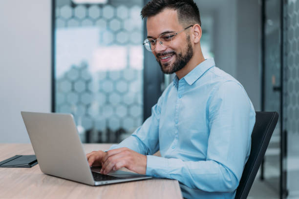 istock Successful businessman in modern office working on laptop. 1837429461
