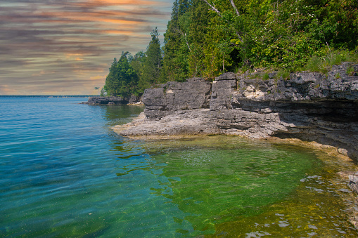 Red granite and pine trees on the Canadian Shield in Killarney, Ontario, Canada on a summer day