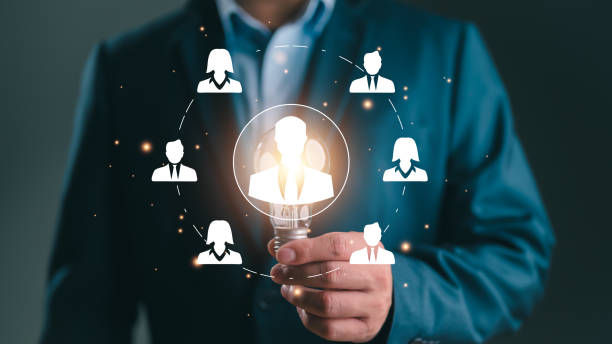istock Businessman showing virtual human icon on lightbulb for business CRM or Customer Relation Management and customer focus target group concept, social media. Digital marketing online. HRM, human manage 1837495185
