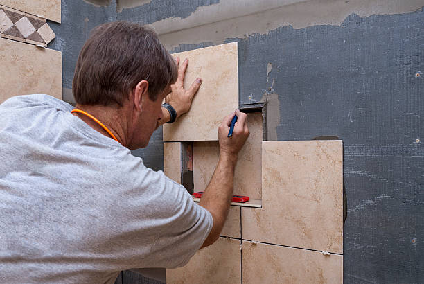 istock Craftsman Measures Shower Tile During Renovation 183750477