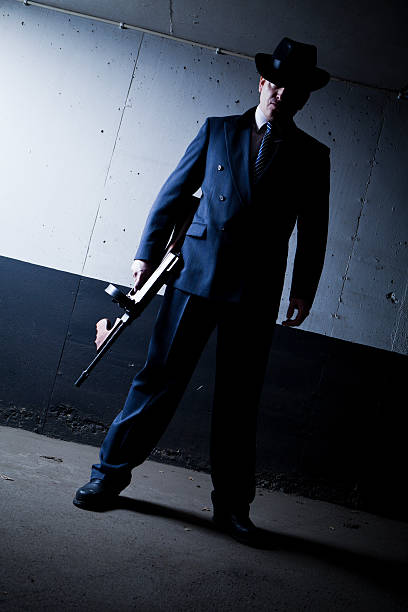 istock Old style gangster with tommy gun in dark setting 183750983