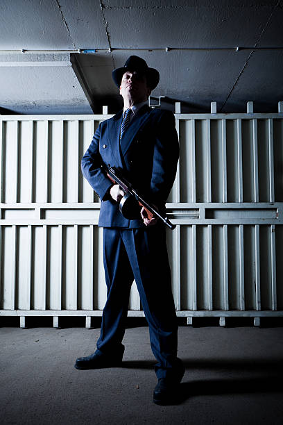 istock Old style gangster with tommy gun in dark setting 183750986