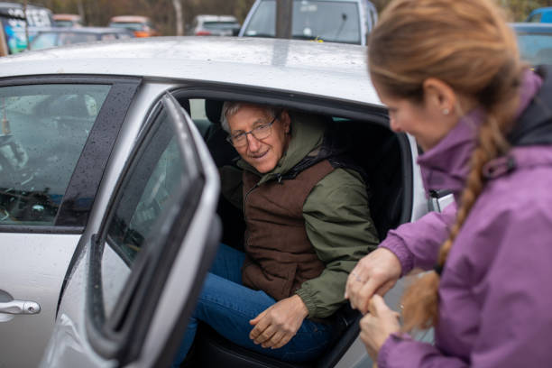 istock Woman helping a senior man get into a car 1837511594