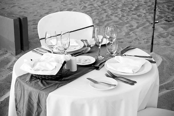 istock gourmet tropicale; romantic dinner table set outdoors on beach 183751224
