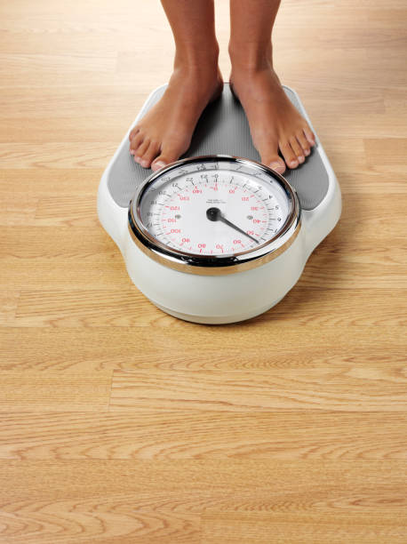 Weighing Scales On A Wooden Floor Stock Photo - Download Image Now - Weight  Scale, Bathroom Scale, Overweight - iStock