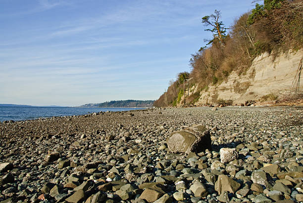Rocky Beach on Puget Sound The landscapes and seascapes of Puget Sound are a constant source of inspiration for photographers. This picture of a rocky beach was photographed from Saltwater State Park near Des Moines, Washington State, USA. jeff goulden puget sound stock pictures, royalty-free photos & images