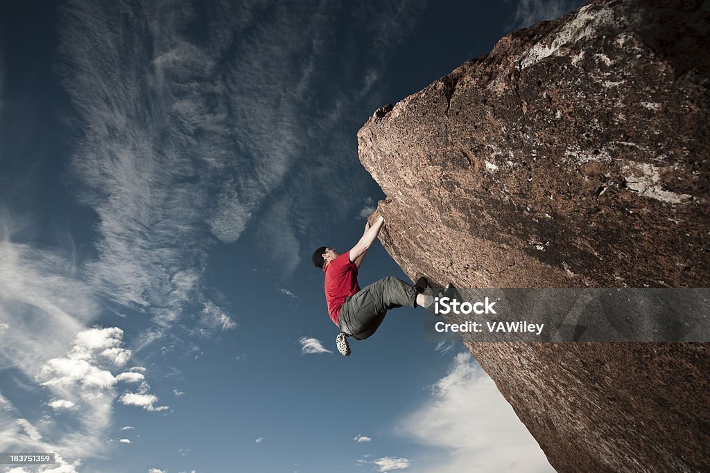 Hold on A man rock climbing a steep cliff Activity Stock Photo