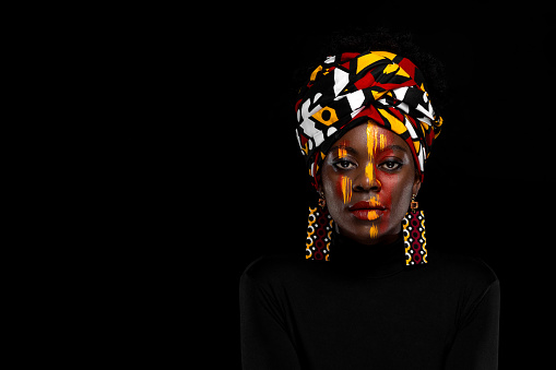 African girl in a national headdress. Copy space to advertise an event, Black Friday discounts, or a music album. Cover for a piece of music, album, mixtape or book