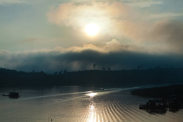 Sunrise over a Lake with Mountains in Thailand stock photo