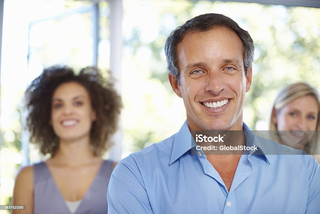 Leader with his team Portrait of successful male leader standing in front of his team 40-49 Years Stock Photo