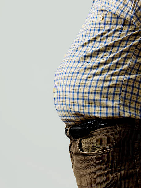 Overweight Side view of a fat belly with copy space to the left pot belly stock pictures, royalty-free photos & images