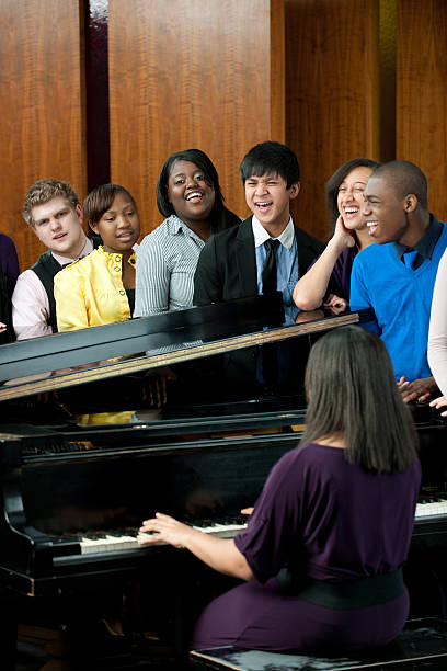 Singing A diverse group of young adults singing in church. - Buy credits sing praise stock pictures, royalty-free photos & images