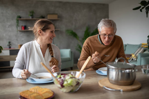 istock Father and daughter eating soup at home 1837529952