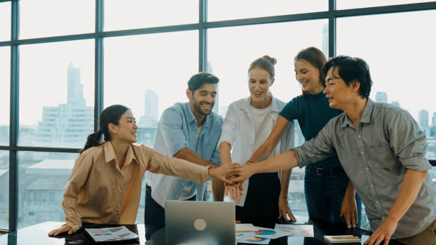 istock Multicultural smart businesspeople putting hand together at office. Tracery 1837531040