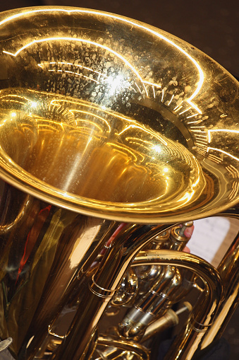 Big close-up of the bell of a concert tuba.
