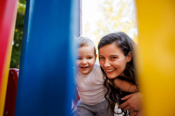 istock Toddler having fun on the playground with his mother 1837539926