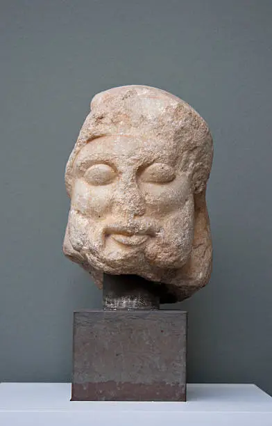 "Head of the god Hermes, Boeotia, c. 500 BC. Marble.The head was mounted on top of a pillar, on the front of which male genitals was carved. This sculptural type is known as a herm, because the earliest examples were topped by the head of Hermes. Herms stood near the roads and boundaries.Ancient art photographed in Carlsberg Glyptotek, Copenhagen, Denmark."