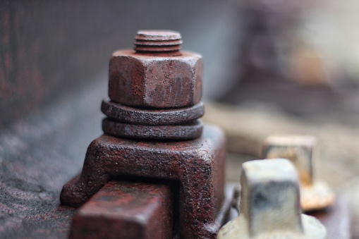 close up rusty screw nuts and bolts on railroads. close up photo. selective focus photo