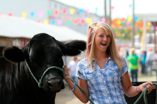 a happy girl with 4-H steer