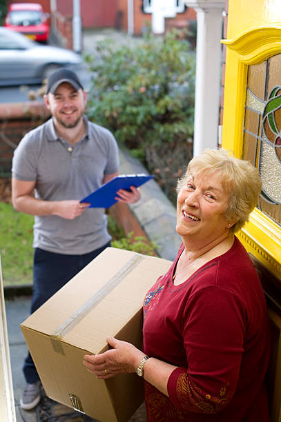 istock Senior woman happy with her delivered parcel 183754512