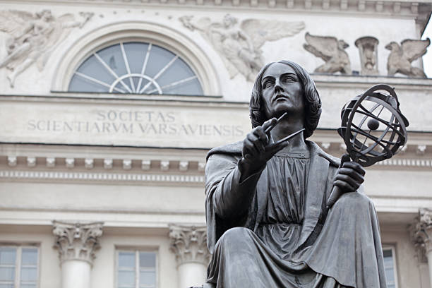 Statue of Nicolaus Copernicus in Warsaw, Poland. Nicolaus Copernicus was a Renaissance astronomer and the first person to formulate a comprehensive heliocentric cosmology, which displaced the Earth from the center of the universe. astronomer photos stock pictures, royalty-free photos & images