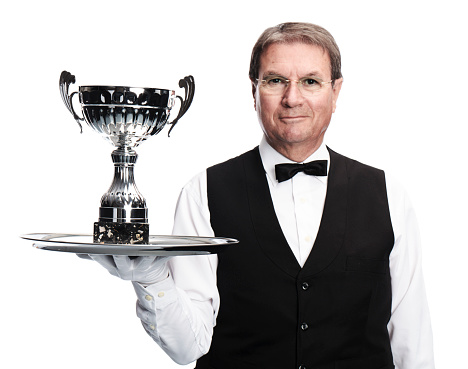 butler with trophy on tray