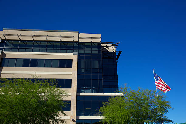 American Scottsdale Arizona Office builidng American flaf outside an Arizona business  in Scottsdale,business park in clear sunny day with desert landscaping Palo Verde trees southwest usa architecture building exterior scottsdale stock pictures, royalty-free photos & images