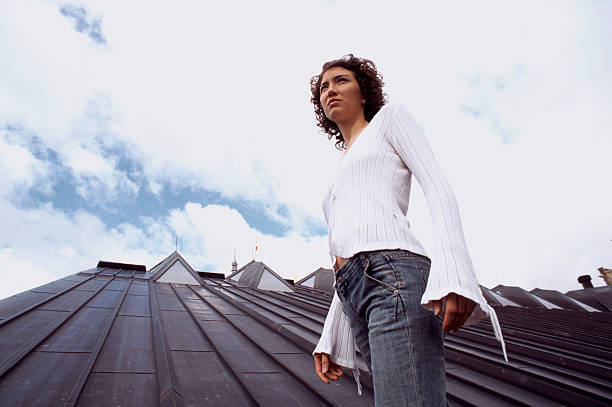 istock Young woman standing on rooftop. 183755548