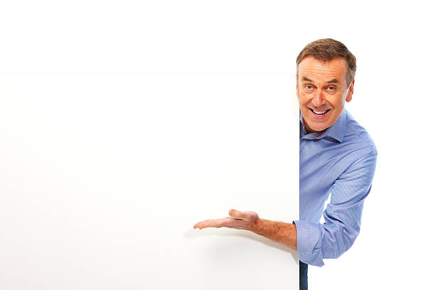 Mature man isolated on white background holding board Man pointing at white board. Isolated on white and good for cutout. looking around stock pictures, royalty-free photos & images