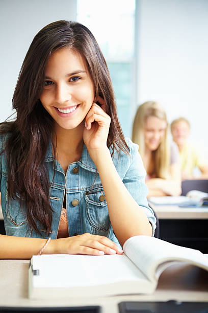 istock Beautiful, young girl smiling in a classroom 183755992