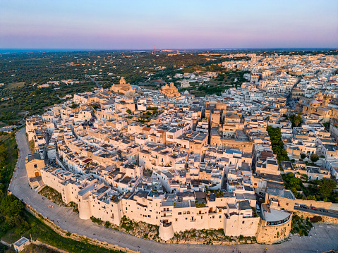 Monopoli from drone, Apulia white town at golden hour sunset