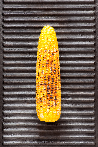 Corn on the cob over iron grill