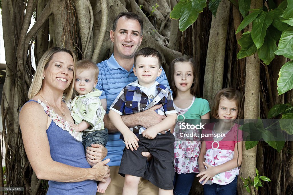 Happy caucasian family of six outdoors Happy smiling family of parents with four children enjoying the outdoors. Click to see more... Family with Four Children Stock Photo