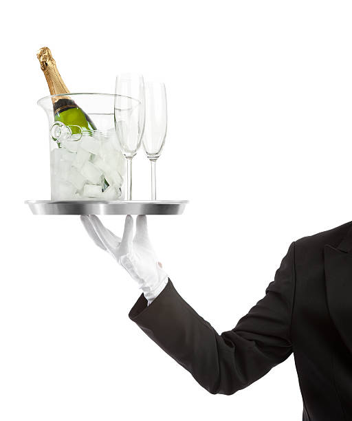 camarero llevando una botella de champaigne con acanaladuras - serving tray silver plate fotografías e imágenes de stock