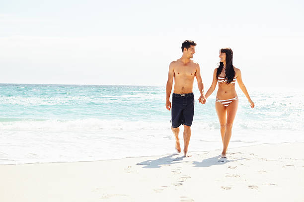 istock Couple walking by the sea 183757404