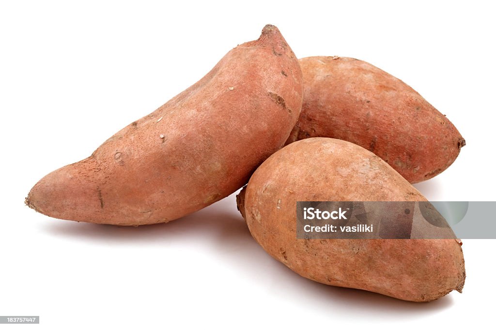 Close-up of three Raw sweet potatoes Three sweet potatoes isolated on white. Sweet Potato Stock Photo