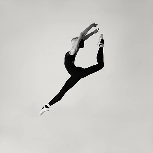 Jumping modern ballet dancer Professional modern ballet dancer jumping in studio. contemporary dance stock pictures, royalty-free photos & images