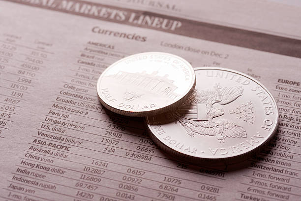istock dollar coins on financial newspaper 183758008
